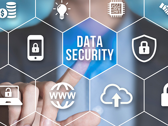 A person with a digital hexagonal interface featuring icons related to cybersecurity data protection. At the center, the phrase 'DATA SECURITY' is prominently displayed. Some of the other icons represent: encryption, secure cloud storage, and internet security.