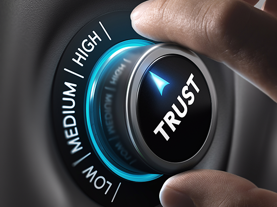 Hand turning dial labeled TRUST to HIGH, symbolizing the importance of building public trust during government privatization.
